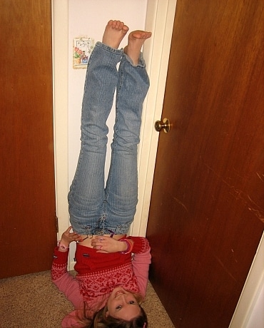 Kitty in jeans sitting on her apartment floor