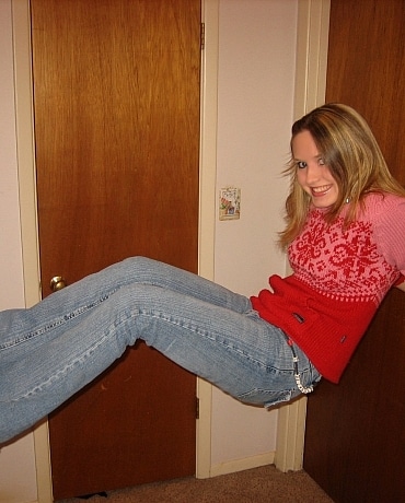 Kitty in jeans sitting on her apartment floor