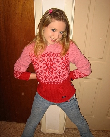 Kitty in jeans sitting on her apartment floor