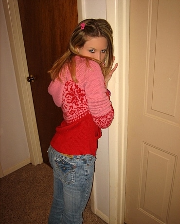 Kitty in jeans sitting on her apartment floor