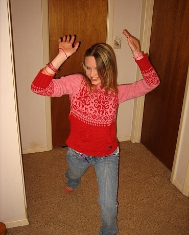 Kitty in jeans sitting on her apartment floor