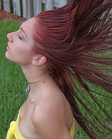 Nathaly with red hair outside posing