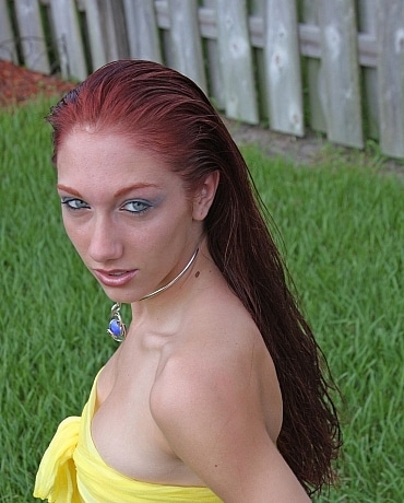 Nathaly with red hair outside posing