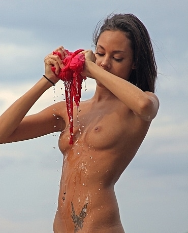 Danica drenches herself with beach water