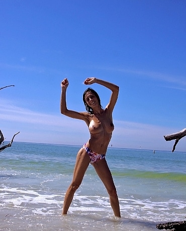 Michelle laying on the sandy beach