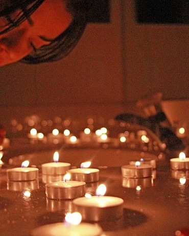 Layla puts out candles on her bath counter top